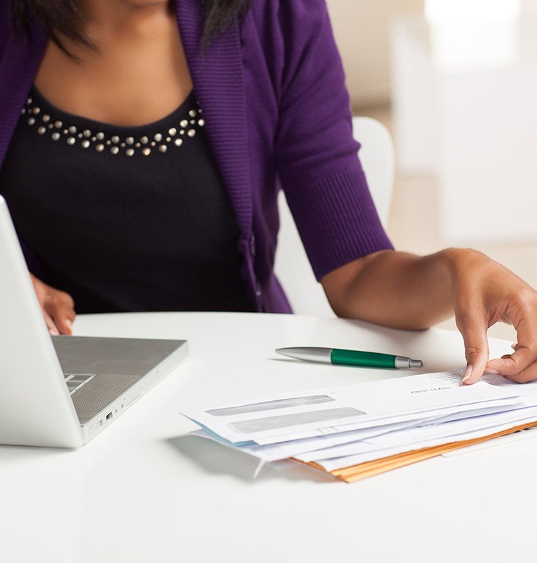 Woman with laptop and mails